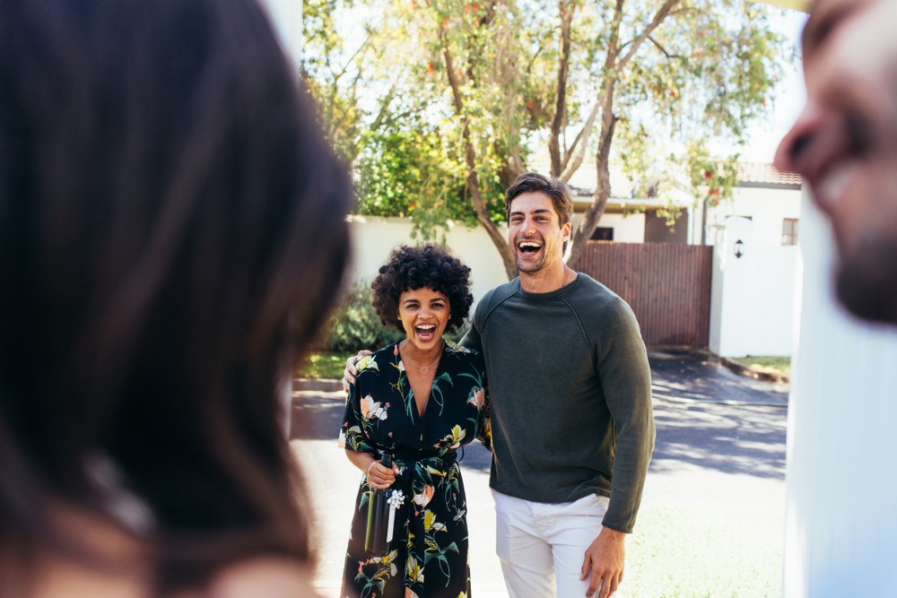 Couple walking up to a housewarming party